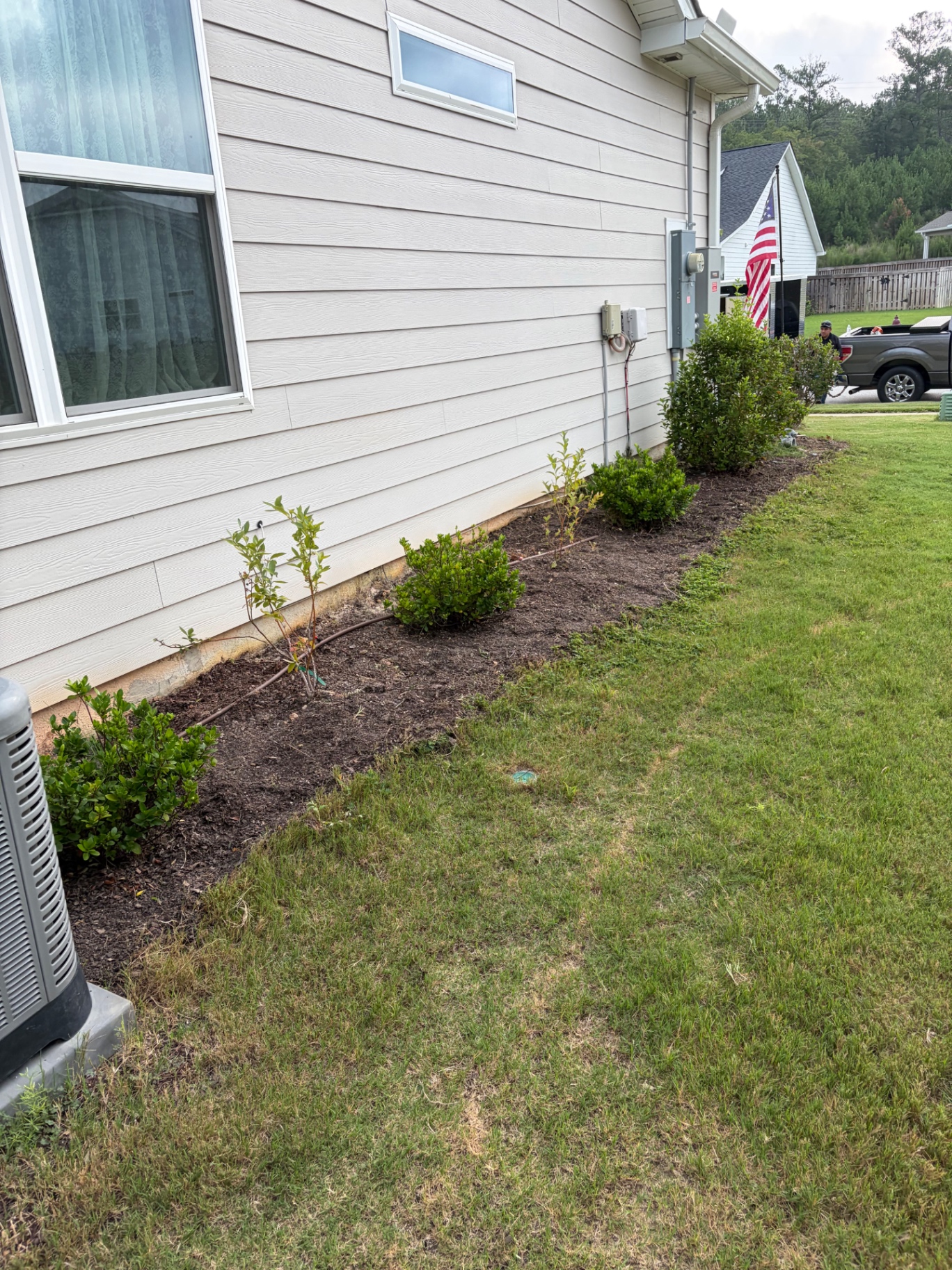 Front corner bed cleared, mulched, and tidy after weed removal by RC Landscaping